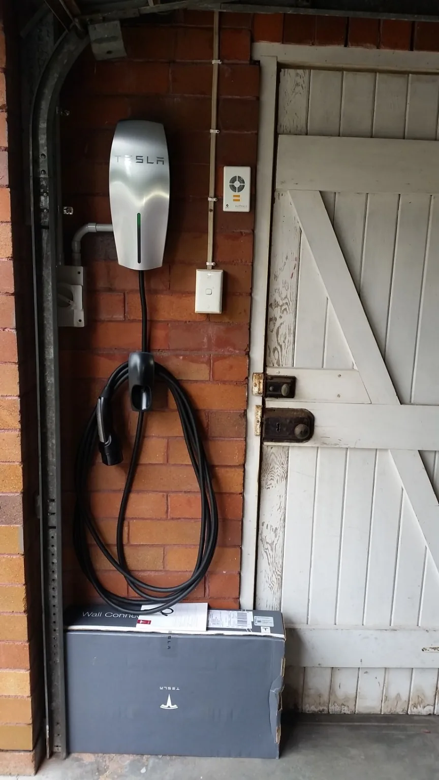 Tesla Wall Connector installed neatly on brick wall