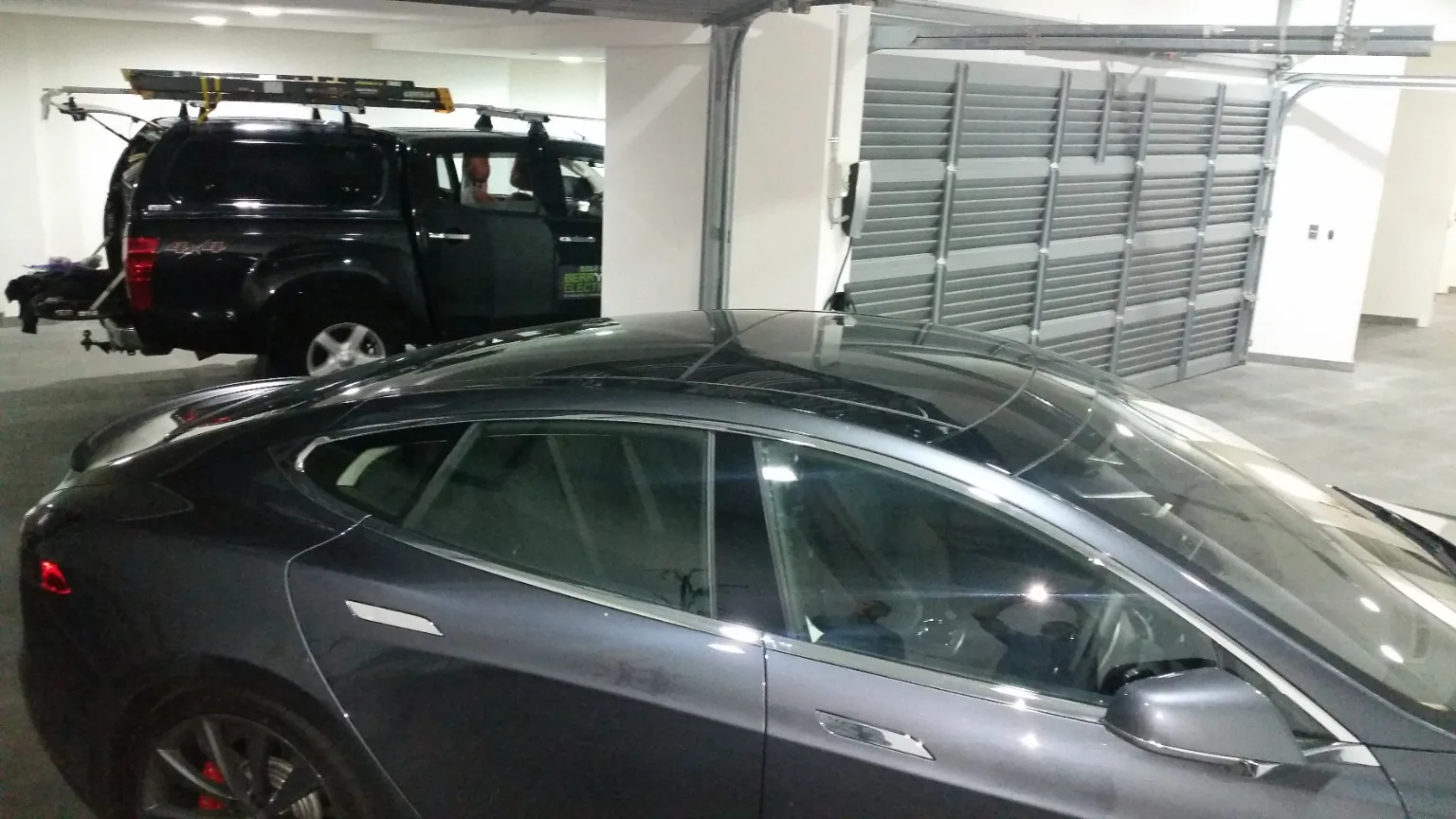 Tesla electric vehicle and EV charging installation in a residential garage