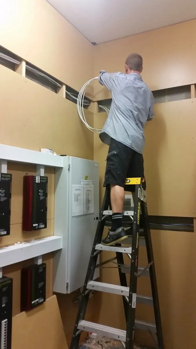 Electrician carrying out work inside a residential switchboard